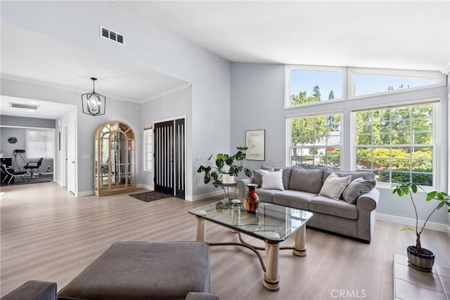7701 Quimby Ave, West Hills, CA 91304 - living area featuring light wood finished floors, a chandelier, and crown molding
