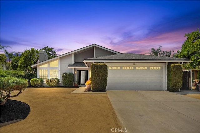 7701 Quimby Ave, West Hills, CA 91304 - view of front of property featuring driveway, an attached garage, and a chimney