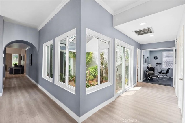 7701 Quimby Ave, West Hills, CA 91304 - hall with arched walkways, light wood-style flooring, crown molding, and recessed lighting
