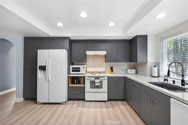 7701 Quimby Ave, West Hills, CA 91304 - kitchen featuring white appliances, a raised ceiling, under cabinet range hood, tasteful backsplash, and recessed lighting