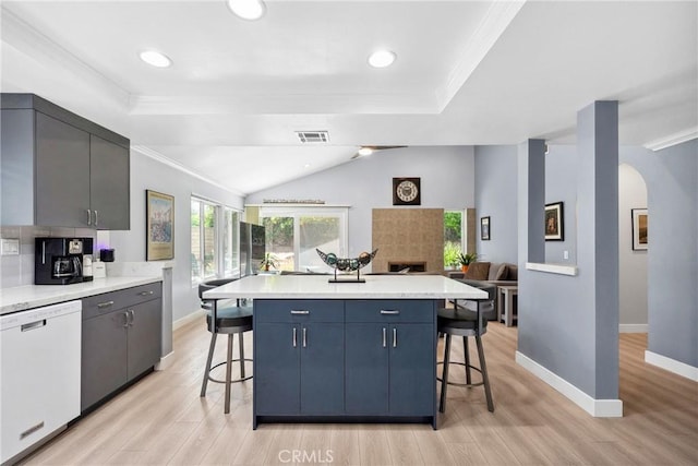 7701 Quimby Ave, West Hills, CA 91304 - kitchen with white dishwasher, a breakfast bar, crown molding, light wood finished floors, and light countertops