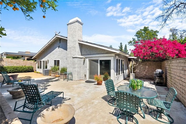 7701 Quimby Ave, West Hills, CA 91304 - rear view of house with stucco siding, a fenced backyard, a patio area, and outdoor dining area
