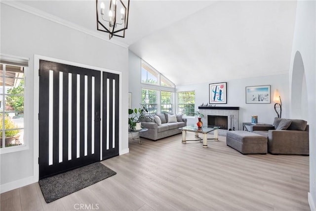 7701 Quimby Ave, West Hills, CA 91304 - entrance foyer with wood finished floors, vaulted ceiling, a chandelier, a fireplace, and ornamental molding