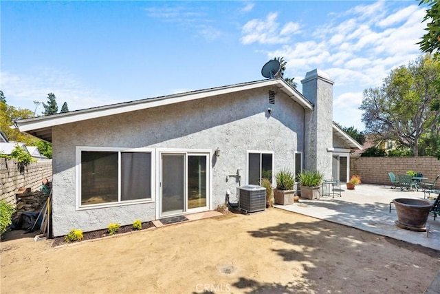 7701 Quimby Ave, West Hills, CA 91304 - back of property with a patio area, stucco siding, and a chimney