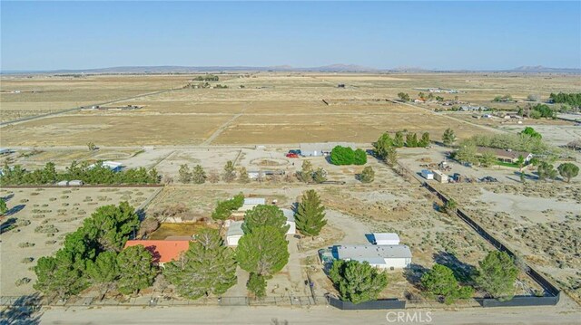 drone / aerial view with a rural view, view of desert, and a mountain view