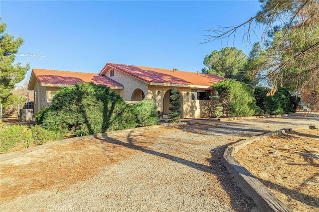 mediterranean / spanish house with stucco siding and a tiled roof