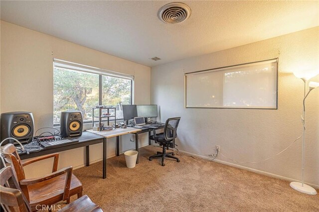 carpeted office space with baseboards and visible vents