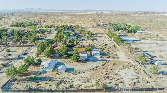 aerial view with a mountain view, a desert view, and a rural view