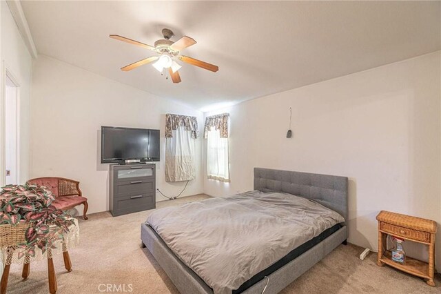 bedroom featuring light carpet, vaulted ceiling, and ceiling fan