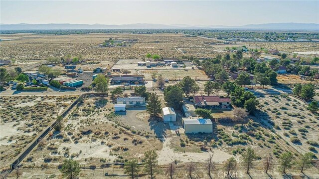 drone / aerial view featuring a mountain view, a rural view, and view of desert