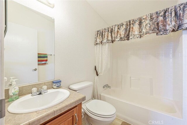 bathroom featuring toilet, vanity, and bathtub / shower combination