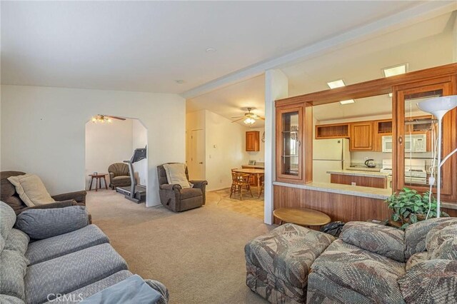 living room with light carpet and ceiling fan