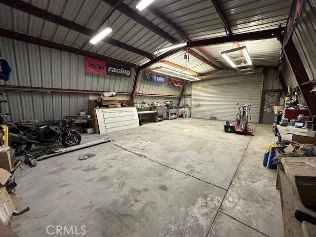 garage with a workshop area and metal wall
