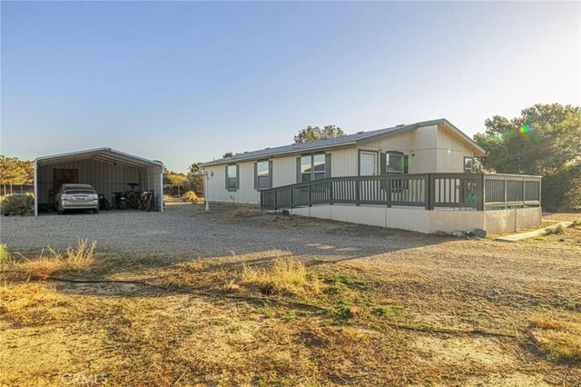 manufactured / mobile home with driveway and a detached carport