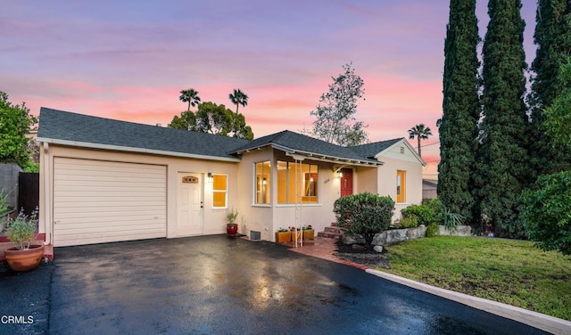 4806 Glenwood Ave, La Crescenta, CA 91214 - view of front of property with asphalt driveway, an attached garage, stucco siding, a yard, and roof with shingles