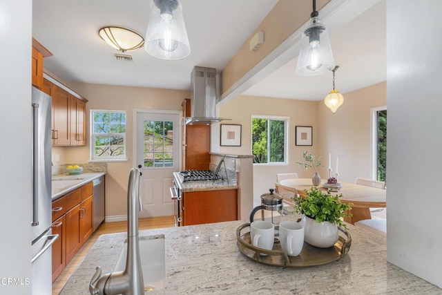 4806 Glenwood Ave, La Crescenta, CA 91214 - kitchen featuring island range hood, brown cabinetry, premium appliances, and hanging light fixtures