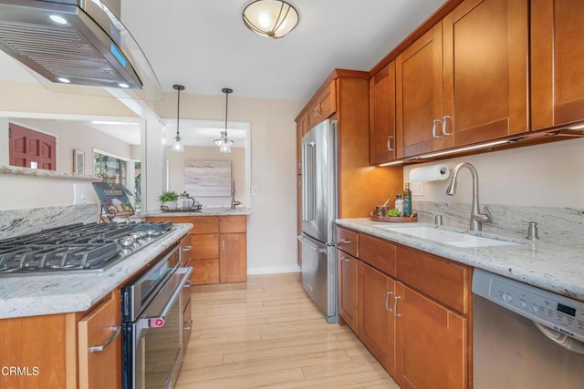 4806 Glenwood Ave, La Crescenta, CA 91214 - kitchen featuring appliances with stainless steel finishes, a sink, under cabinet range hood, brown cabinets, and light stone counters