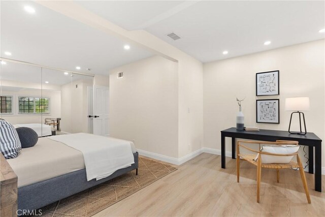 bedroom with baseboards, recessed lighting, visible vents, and light wood-type flooring