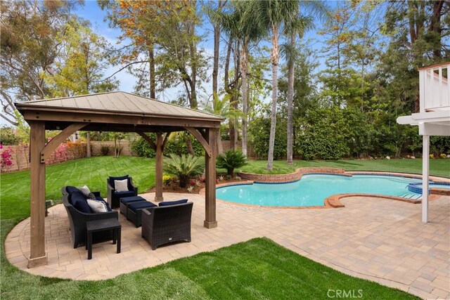outdoor pool featuring a patio area, a fenced backyard, a gazebo, and a yard