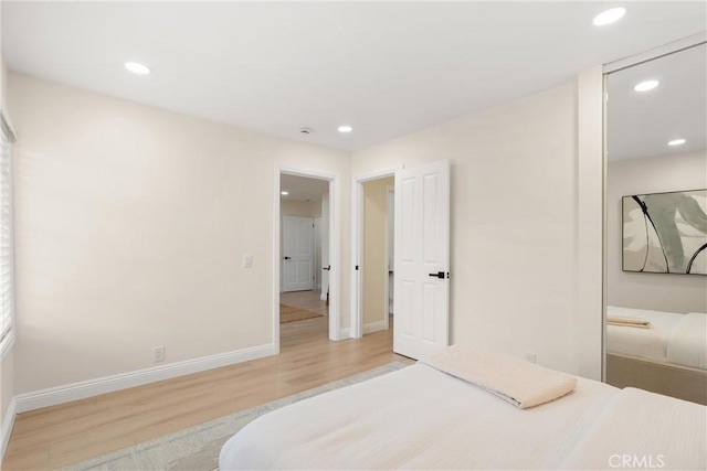 bedroom featuring recessed lighting, wood finished floors, and baseboards