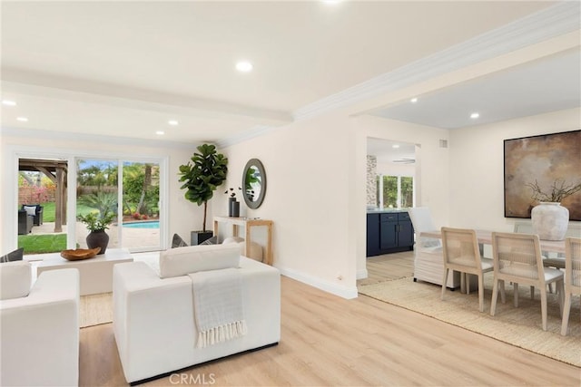 living area with baseboards, recessed lighting, light wood-style floors, and plenty of natural light