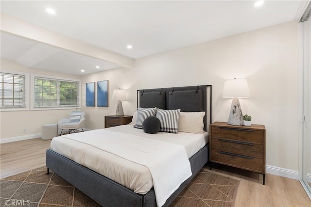 bedroom with recessed lighting, wood finished floors, baseboards, and beamed ceiling