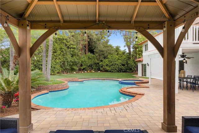 view of swimming pool featuring a patio area, a ceiling fan, a gazebo, and a pool with connected hot tub