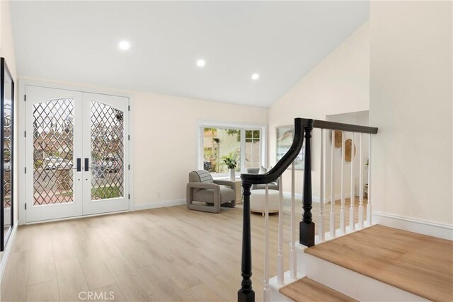 interior space with french doors, baseboards, recessed lighting, wood finished floors, and high vaulted ceiling