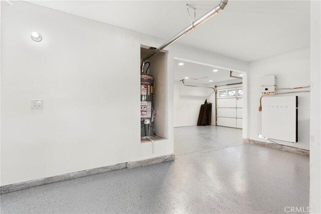 garage featuring water heater and recessed lighting