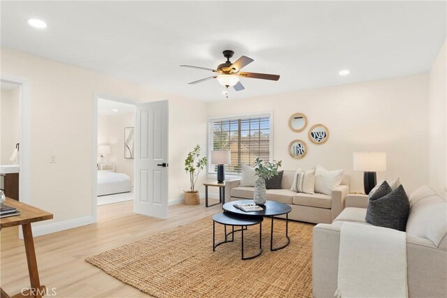 living area featuring wood finished floors, ceiling fan, recessed lighting, and baseboards