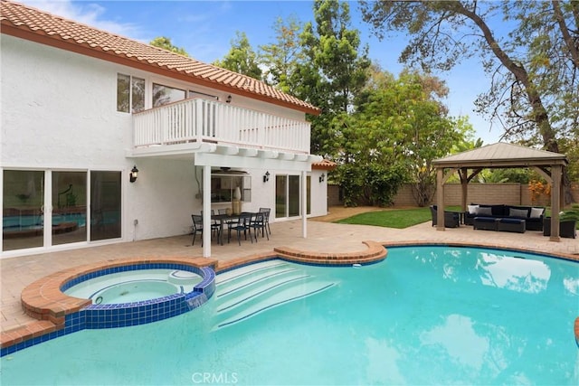 view of swimming pool with a gazebo, a patio area, a fenced backyard, an outdoor living space, and a pool with connected hot tub