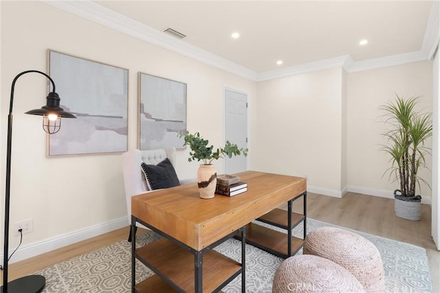 home office with ornamental molding, visible vents, light wood finished floors, and baseboards