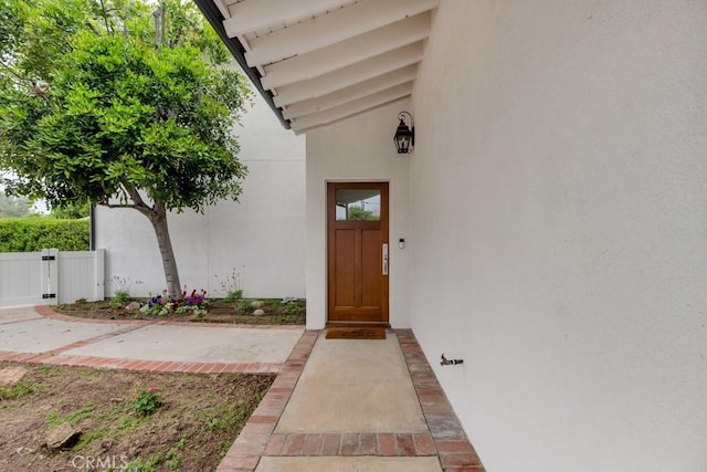 22724 Califa St, Woodland Hills, CA 91367 - view of exterior entry with stucco siding and a gate