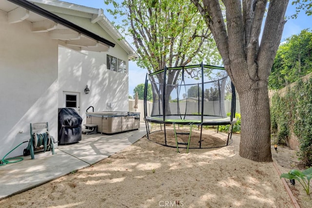 22724 Califa St, Woodland Hills, CA 91367 - fenced backyard with a trampoline, a patio, and a hot tub