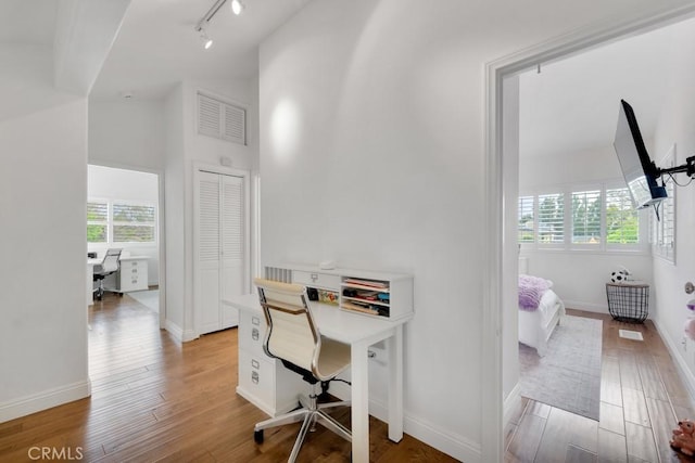 22724 Califa St, Woodland Hills, CA 91367 - office area featuring light wood-style floors, track lighting, baseboards, and high vaulted ceiling