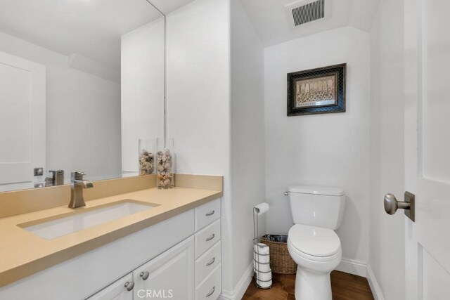 22724 Califa St, Woodland Hills, CA 91367 - bathroom featuring toilet, vanity, wood finished floors, and baseboards