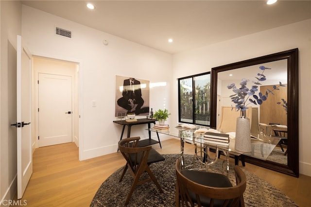 home office with recessed lighting, visible vents, and light wood-type flooring