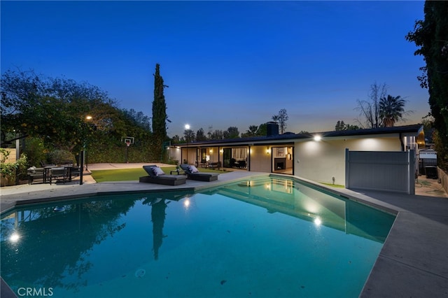 pool with an outdoor hangout area and a patio area