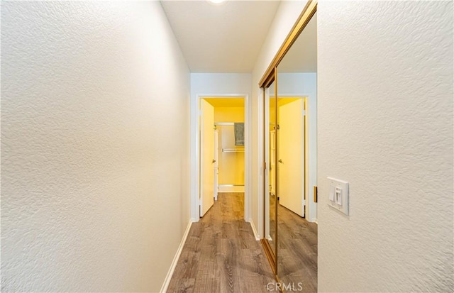 65 Rambling Ln, Aliso Viejo, CA 92656 - corridor featuring baseboards, a textured wall, and wood finished floors
