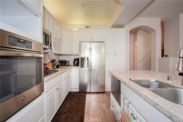 803 Maplewood, Irvine, CA 92618 - kitchen featuring light wood finished floors, appliances with stainless steel finishes, white cabinetry, and a sink