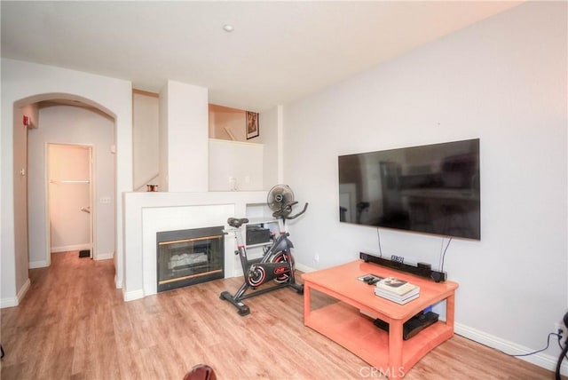 803 Maplewood, Irvine, CA 92618 - living room with arched walkways, wood finished floors, a tile fireplace, and baseboards
