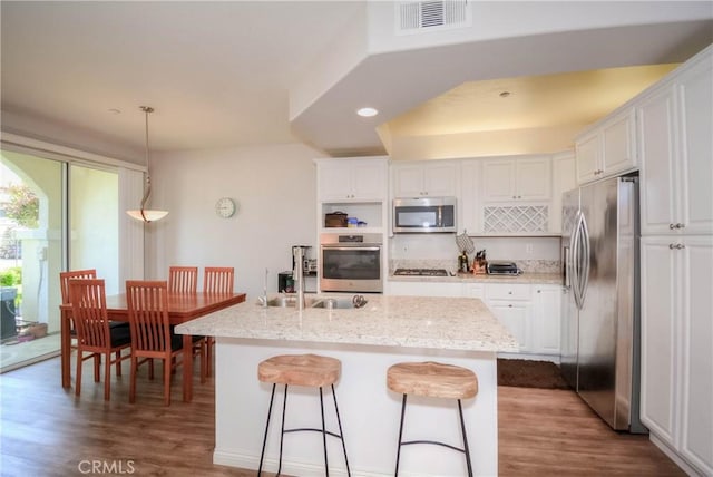 803 Maplewood, Irvine, CA 92618 - kitchen with white cabinets, wood finished floors, stainless steel appliances, and visible vents