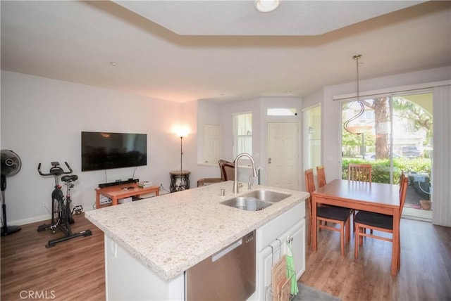803 Maplewood, Irvine, CA 92618 - kitchen with stainless steel dishwasher, wood finished floors, a sink, an island with sink, and white cabinetry