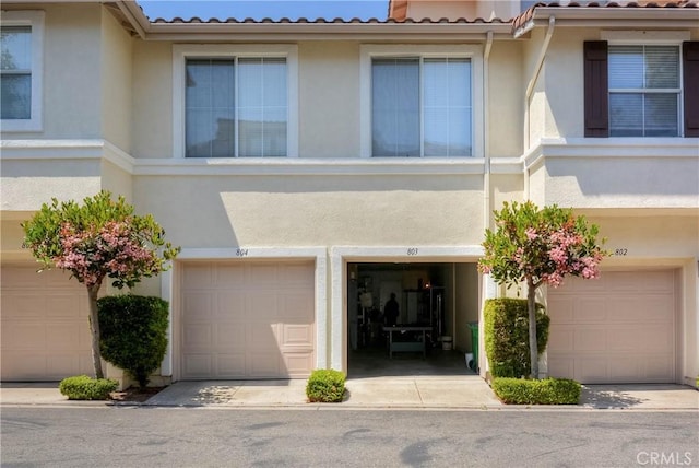 803 Maplewood, Irvine, CA 92618 - townhome / multi-family property with stucco siding, a tile roof, and a garage