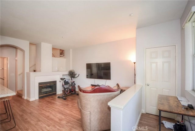 803 Maplewood, Irvine, CA 92618 - living area featuring a glass covered fireplace, wood finished floors, and arched walkways