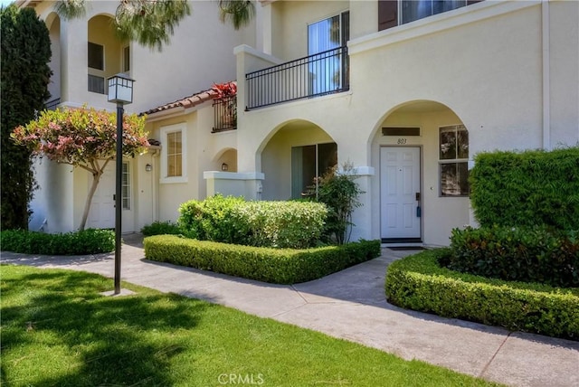 803 Maplewood, Irvine, CA 92618 - doorway to property featuring stucco siding and a balcony