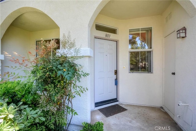 803 Maplewood, Irvine, CA 92618 - doorway to property featuring visible vents and stucco siding