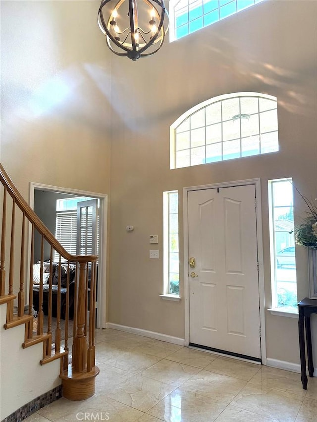 5170 Coronado St, Chowchilla, CA 93610 - foyer entrance featuring baseboards, stairs, a towering ceiling, and a notable chandelier