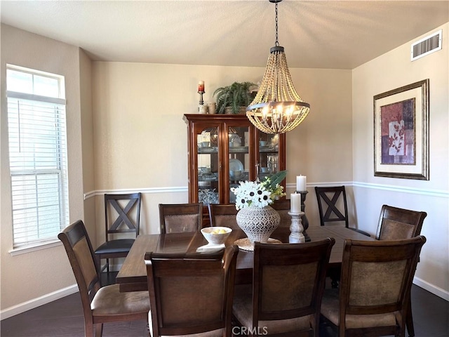 5170 Coronado St, Chowchilla, CA 93610 - dining area with an inviting chandelier, baseboards, wood finished floors, and visible vents