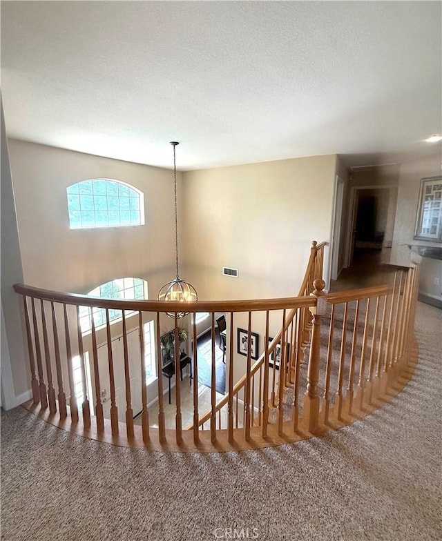 5170 Coronado St, Chowchilla, CA 93610 - stairway with carpet flooring, a chandelier, and visible vents